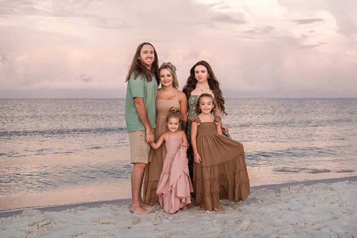 Sunrise family portrait at Mexico Beach Florida with pink sky by Aimee V Photography